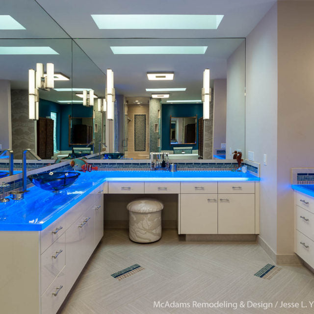 blue countertops from lights in a bathroom